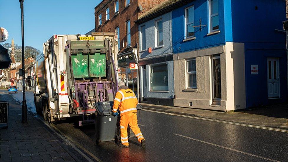 Council bin worker collecting domestic waste from households in Ipswich