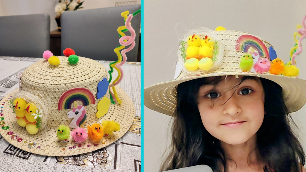 Hanna's Easter bonnet which features a nest with chicks and eggs, some more colourful chicks, rainbow with unicorn and some colourful gems