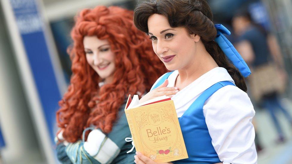 Disney fans in princess costumes at the D23 Expo in California