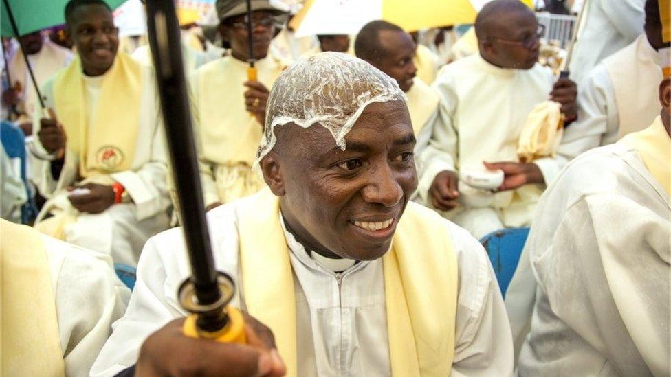 Kenyan priests gather at the University of Nairobi grounds on November 26, 2015, to attend a giant open-air mass held by Pope Francis