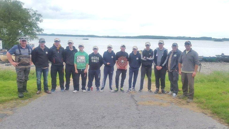 TAFI's award-winning Ulster youth team, with their trophy and coaches