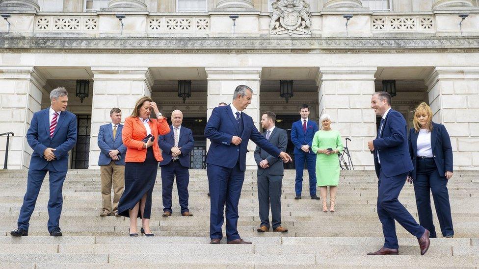 Edwin Poots (centre) pictured with his ministerial team on the steps of Stormont on 8 June.