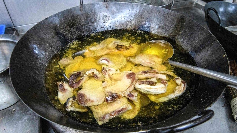 Food left cooking on a hob is seen in the canteen kitchen at the Hong Kong Polytechnic University