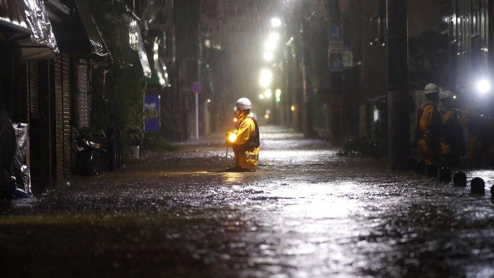 Firefighters patrol on a flooded road due to heavy rains caused by Typhoon Hagibis in Tokyo, Japan, 12 October, 2019.