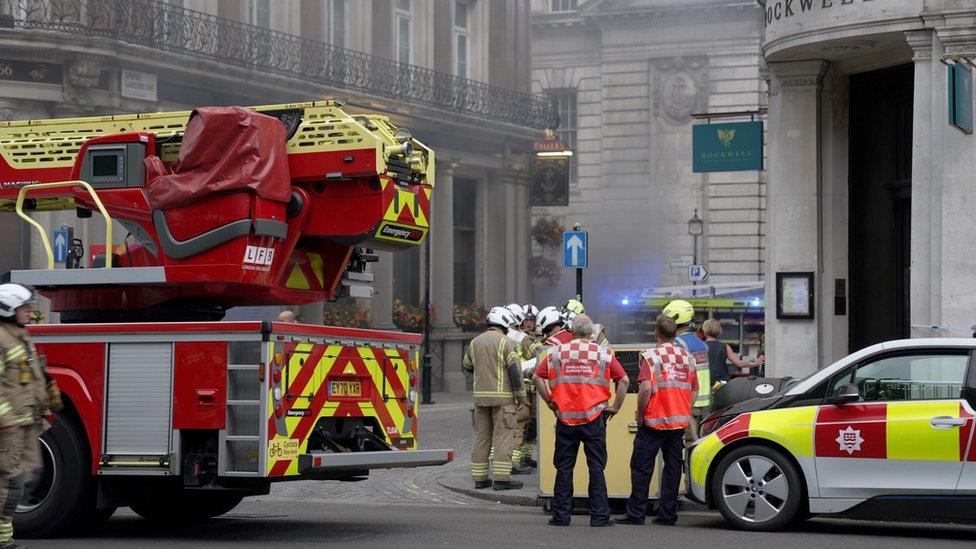 Firefighters gather near the fire at Admiralty pub