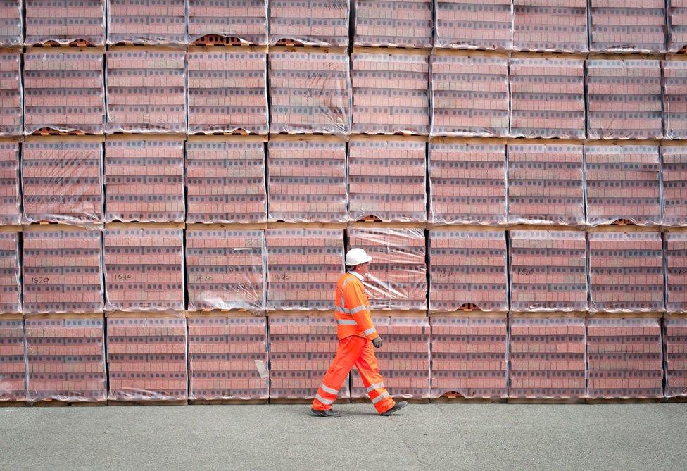 Worker in front of bricks stacks