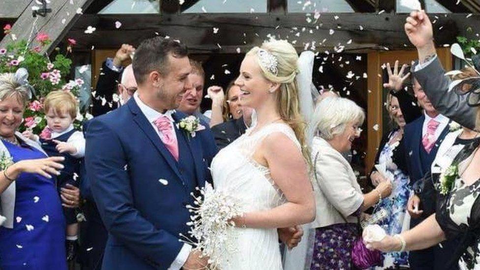 Groom and bride showered with confetti