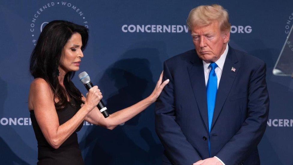 President and CEO of Concerned Women for America Penny Nance (L) prays beside former US President Donald J. Trump