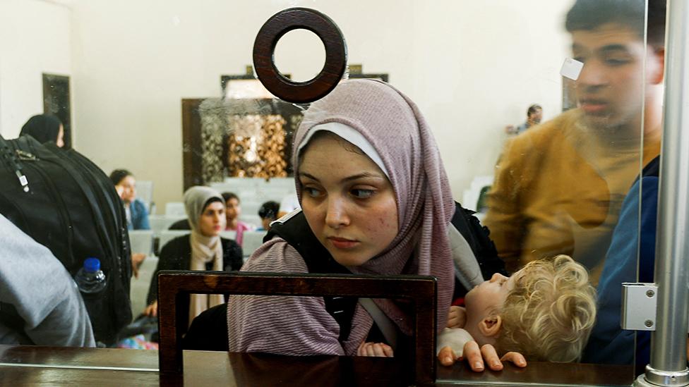 Woman and child at border on the other side of glass screen, Rafah, 3 November