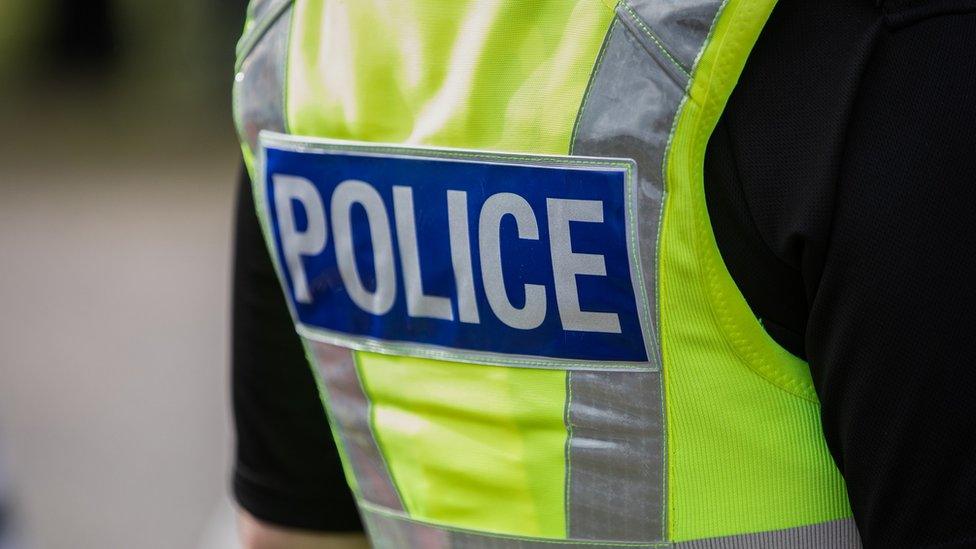 A policeman wearing a hi-vis jacket