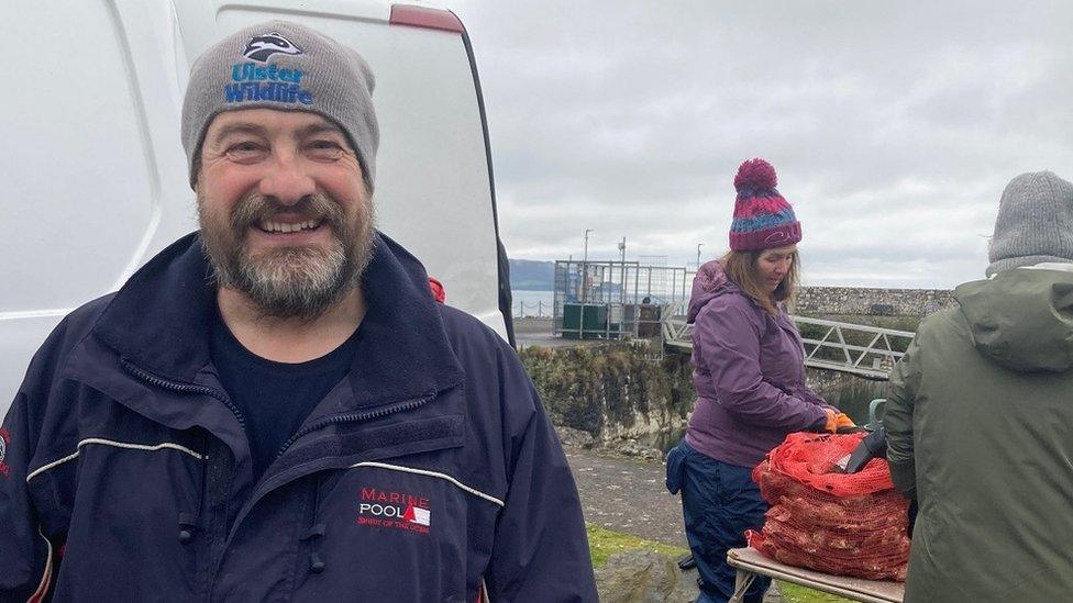 Dave Smyth at Glenarm Marina, with volunteers in the background