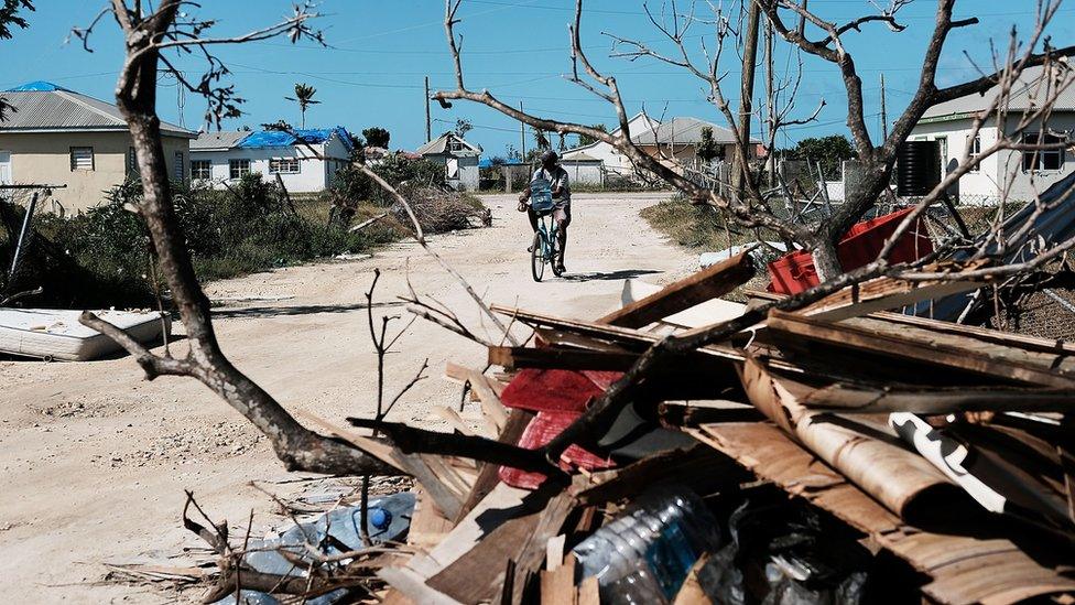 Debris from damaged homes lines a street on the nearly destroyed island of Barbuda on December 8, 2017 in Cordington, Barbuda