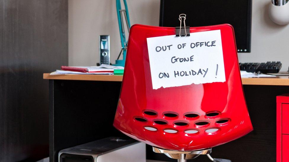 Out-of-office sign taped to chair