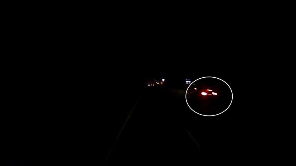 Dashcam footage of a car at night