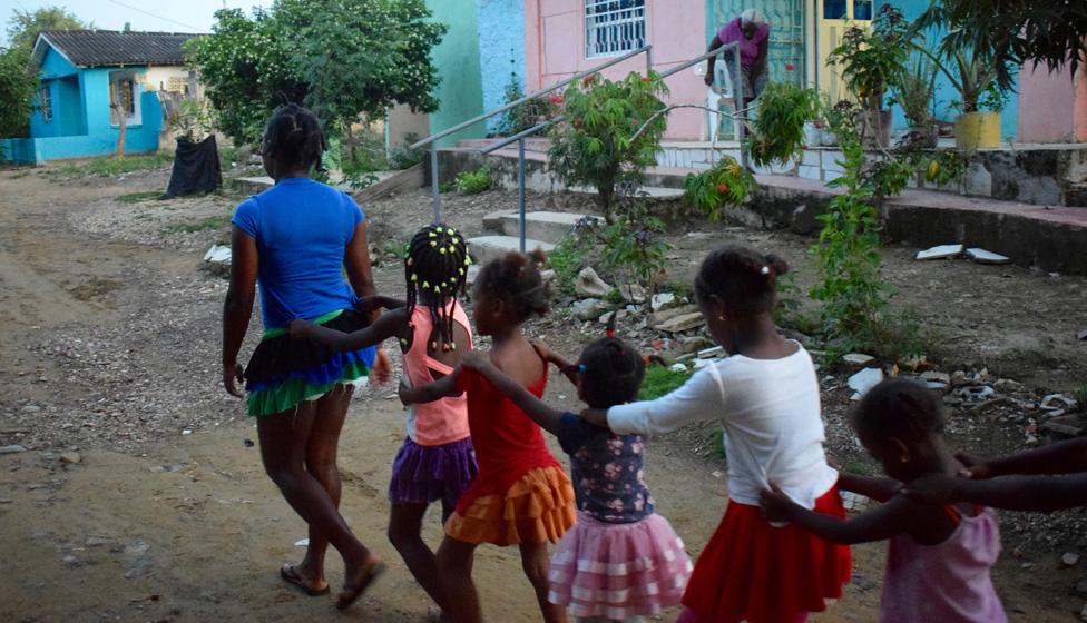 A group of children dance through Palenque