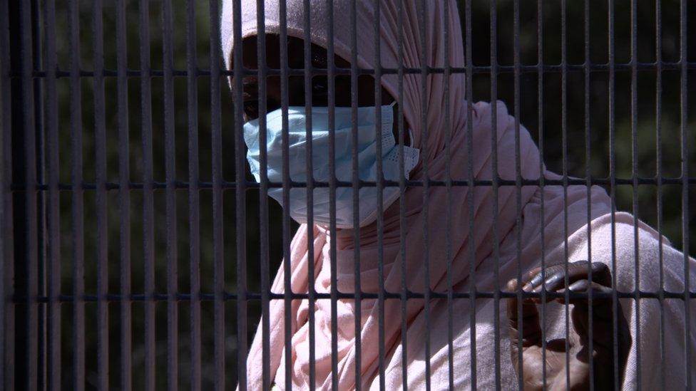 Woman in profile through the railings: Cameroonian Shantleen