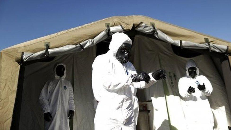 Members of the Brazilian army prepare for a simulated chemical and radiological attack exercise at the Mane Garrincha National Stadium in Brasilia on 9 June, 2014.