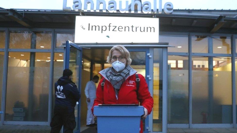 A worker with Covid vaccines sets out to inoculate patients in Dillenberg, Germany