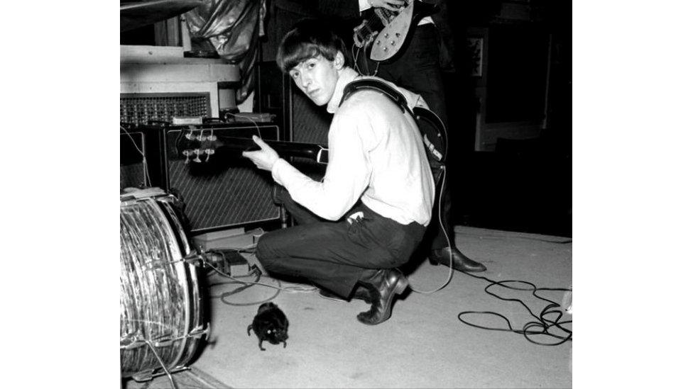 George Harrison from the Beatles pictured with a guitar in the 1960s