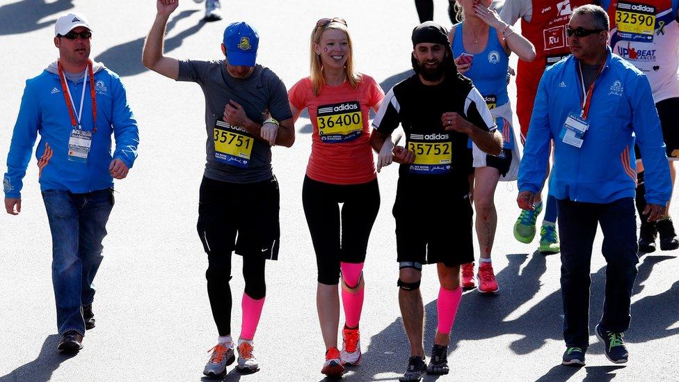 Marathon bombing survivor Adrianne Haslet-Davis crosses the finish line of the 118th Boston Marathon