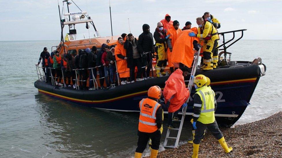 People being taken from a small boat