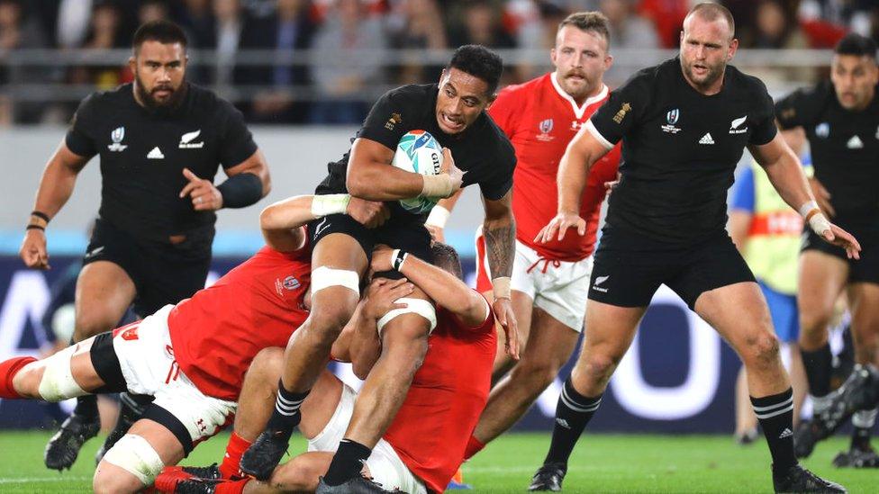 Shannon Frizell of New Zealand is tackled during the Rugby World Cup 2019 Bronze Final match between New Zealand and Wales at Tokyo Stadium on November 01, 2019 in Chofu, Tokyo, Japan. (Photo by Hannah Peters/Getty Images)