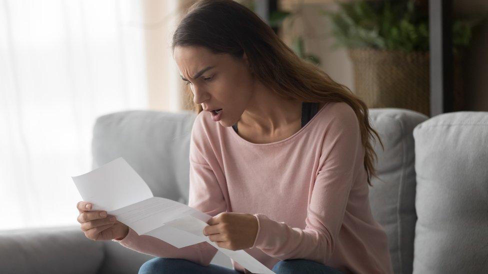 Woman looking at energy bill