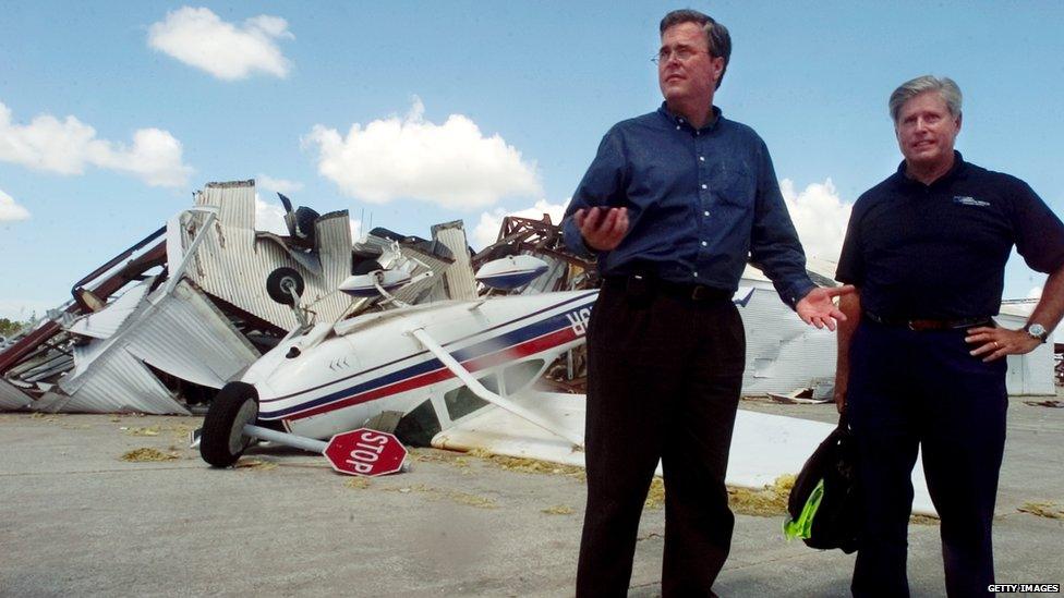 Florida Governor Jeb Bush (R) and state CFO Tom Gallagher stand together at Charlotte County Airport August 15, 2004 in Punta Gorda, Florida.