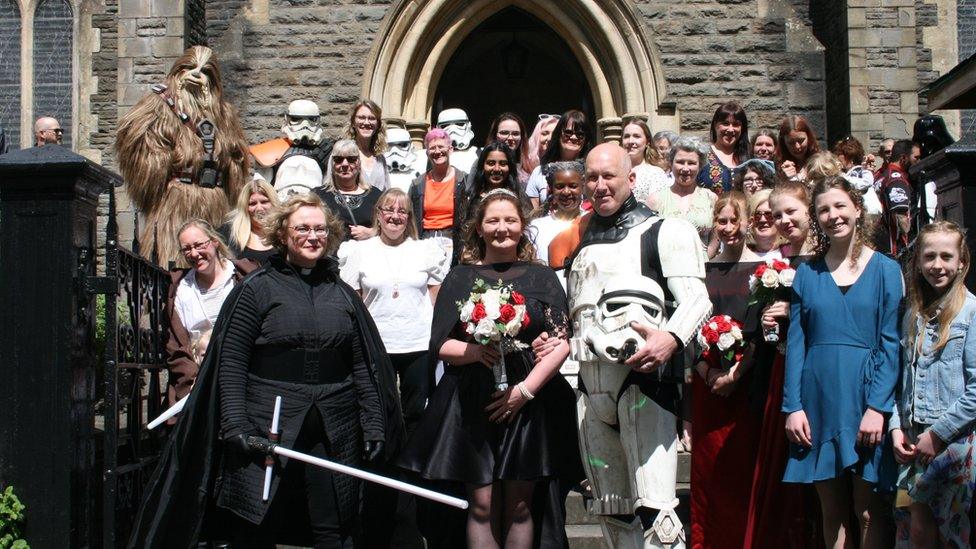 The couple and their guests dressed in Star Wars costumes outside the church