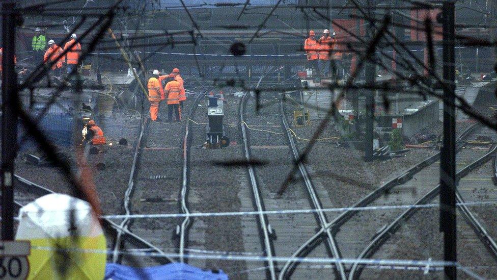 Workmen on the rail track after the train crash at Potters Bar on 10 May 2002