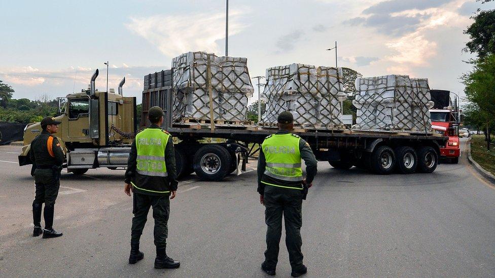 Trucks carrying aid drive towards the Colombia-Venezuela border