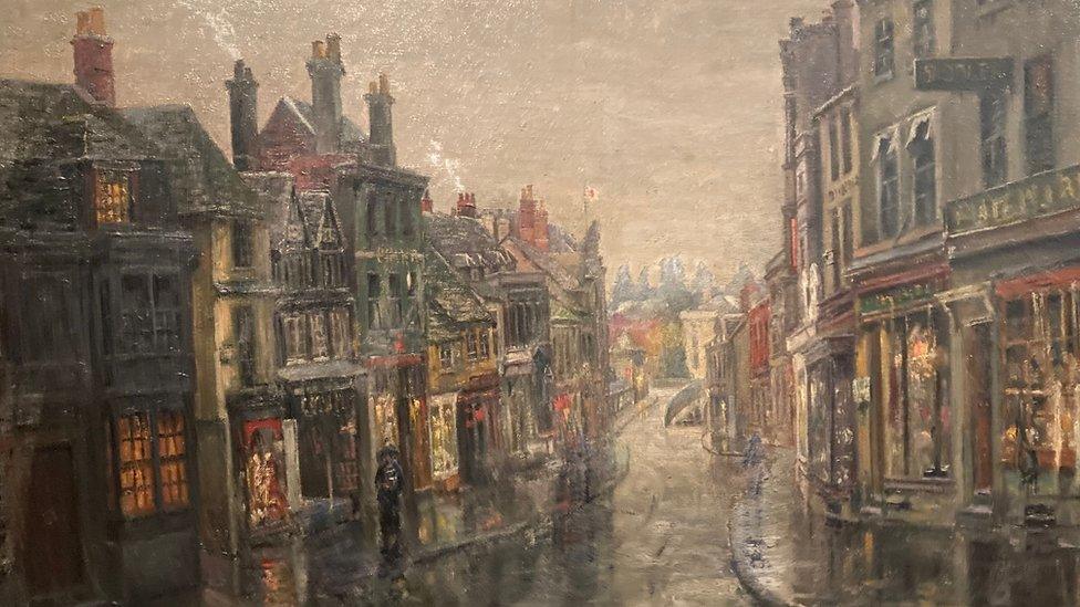 An early 1900s painting of Chippenham's high street with a dark grey sky