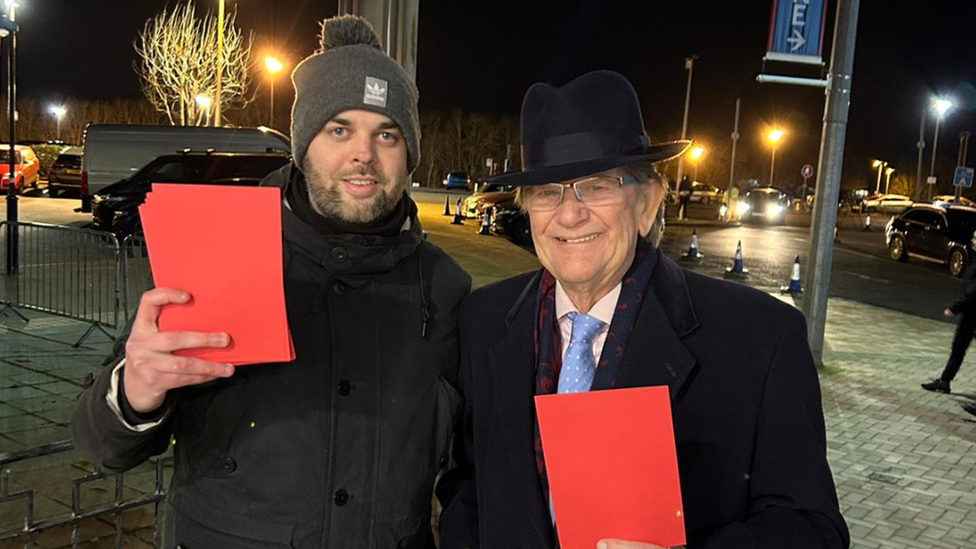 John Madejski with fan holding a red card