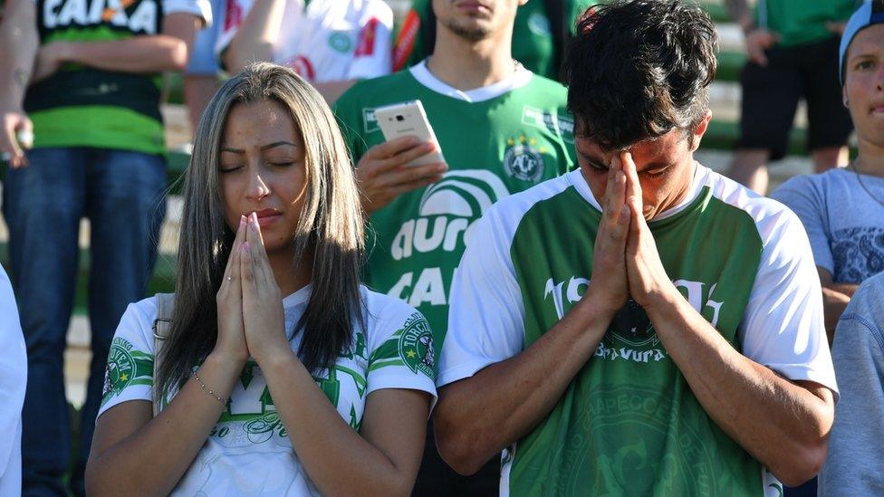 People pay tribute to the players of Brazilian team Chapecoense Real who were killed in a plane accident in the Colombian mountains, at the club"s Arena Conda stadium in Chapeco