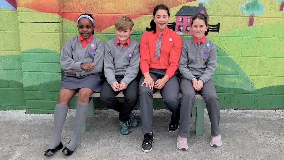 Children sitting on a Buddy Bench