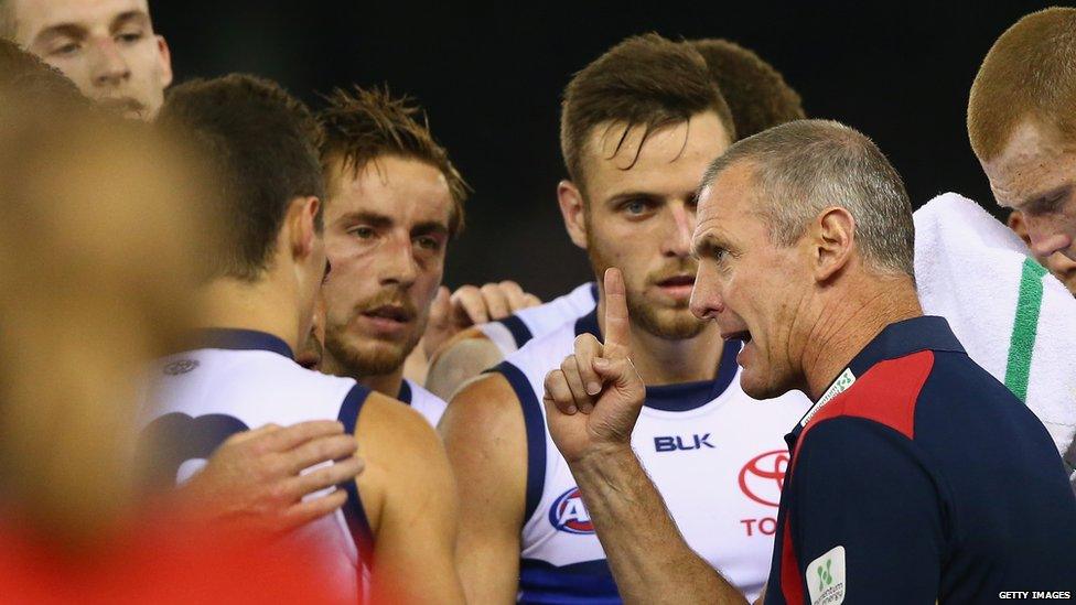 Former Adelaide Crows coach Phil Walsh talking to members of the Crows team during a match