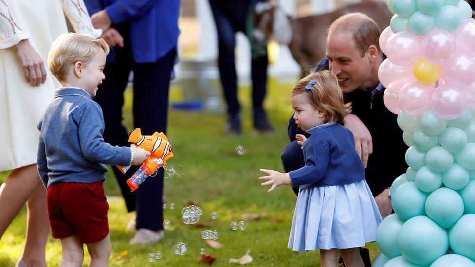 Prince George playing with a bubble gun