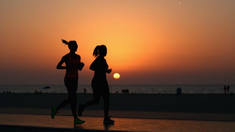 People running on a beach