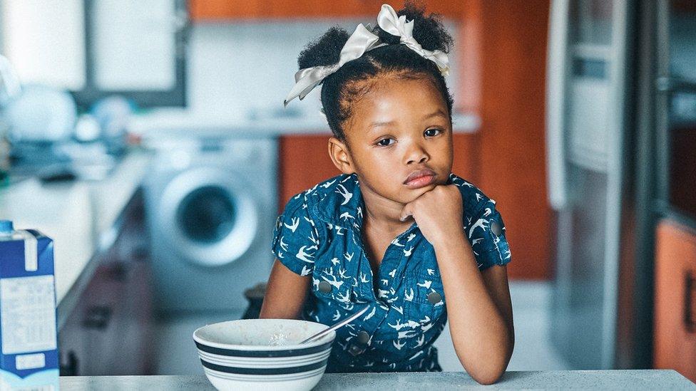 Little girl with cereal bowl (stock image)