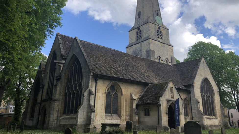 A picture of an old church with a blue sky in the background