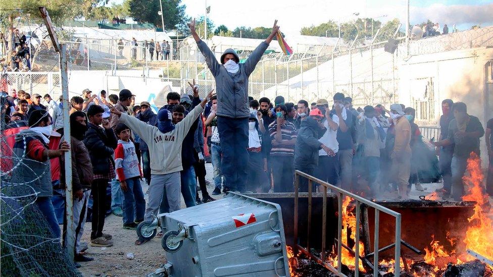 Migrants protest at the Moria migrant detention center Tuesday, April 26, 2016.