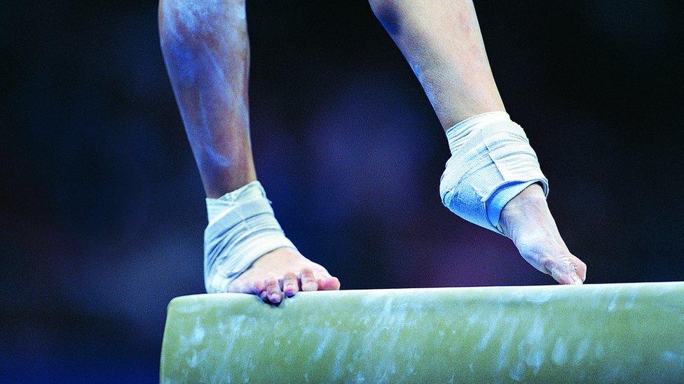 feet on a balance beam