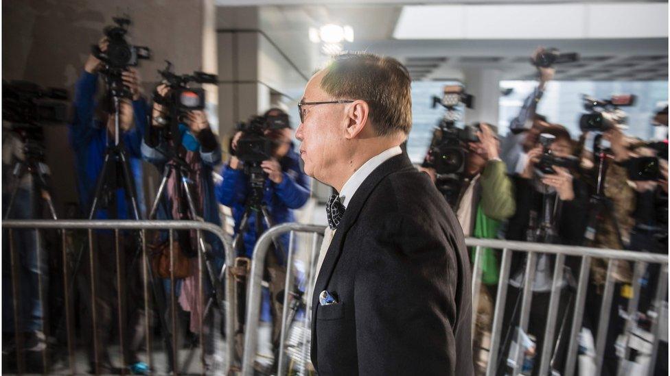 Mr Tsang arriving at court, walking past camera operators from the media. 3 January 2017.