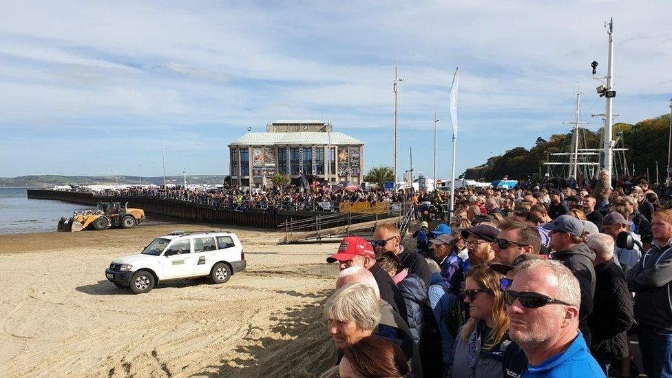 Spectators lining the promenade at Weymouth beach