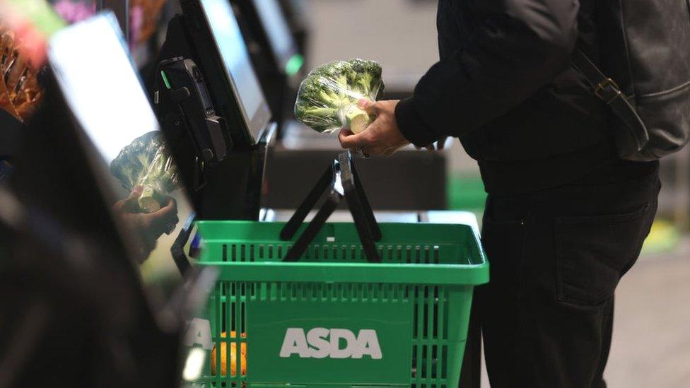 Shopper using a self-checkout at an Asda Express convenience store