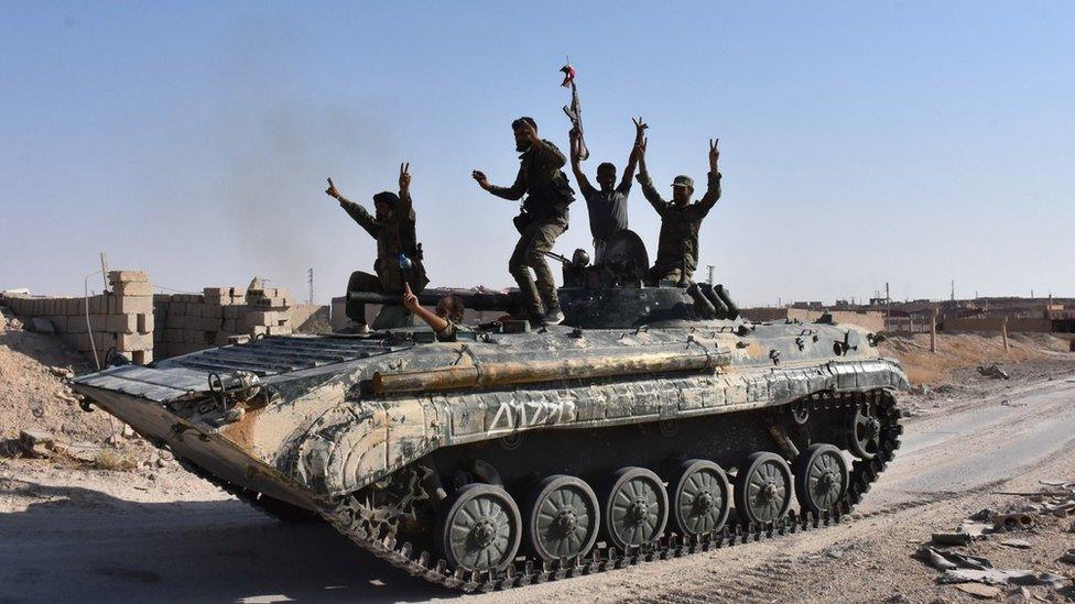 Syrian government forces celebrate in the eastern city of Deir al-Zour on 11 September 2017