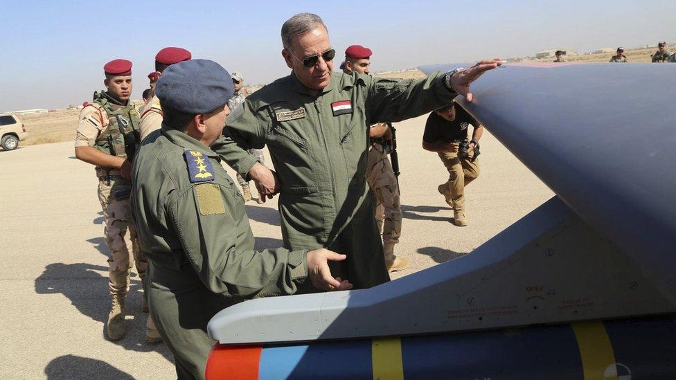 Iraqi Defence Minister Khaled al-Obeidi, centre, inspects the first drone to be used by the Iraqi Air Force Iraqi 10 October 2015