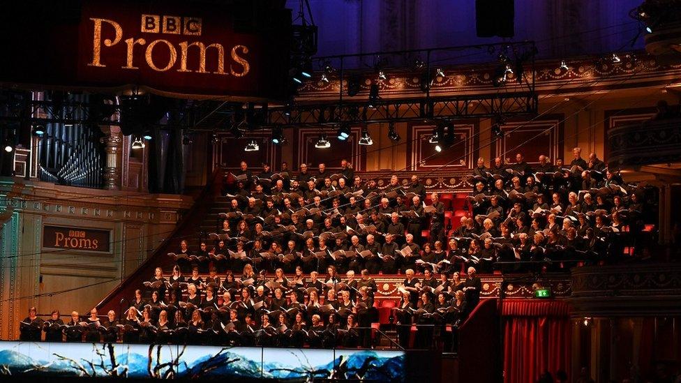 A choir performing onstage at the Royal Albert Hall as part of the BBC proms