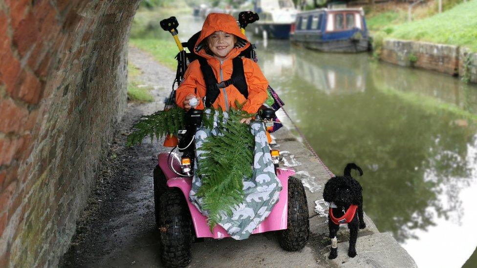 Carmela and her dog by a canal