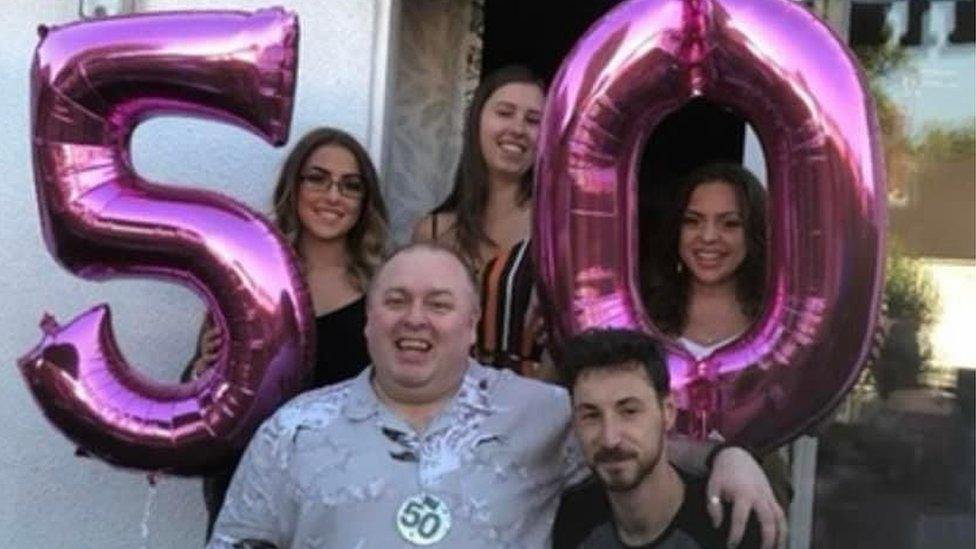 Mark Lang poses for a photo with his children on his 50th birthday